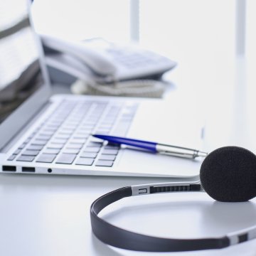 onsip voip service headset laptop pen phone on desk office